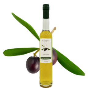 bottle of olive oil in front of a arbequina olive