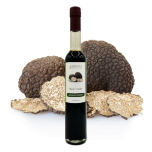 a bottle of balsamic with a cluster of black truffles