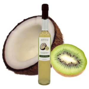 Half a coconut and kiwi behind a bottle of balsamic