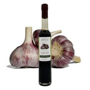 balsamic vinegar in front of a few heads of garlic