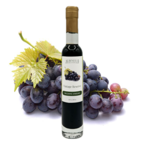 bottle of balsamic vinegar in front of grapes