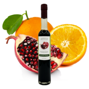balsamic in front of open pomegranate and sliced orange